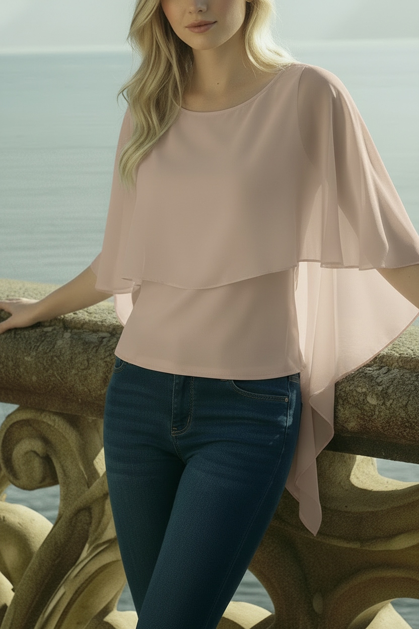 Model wearing mink vizon ruffle chiffon blouse with flowing volan layers